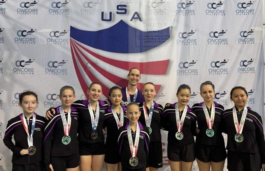 The Boston Synchro Swim team with medals at a championship